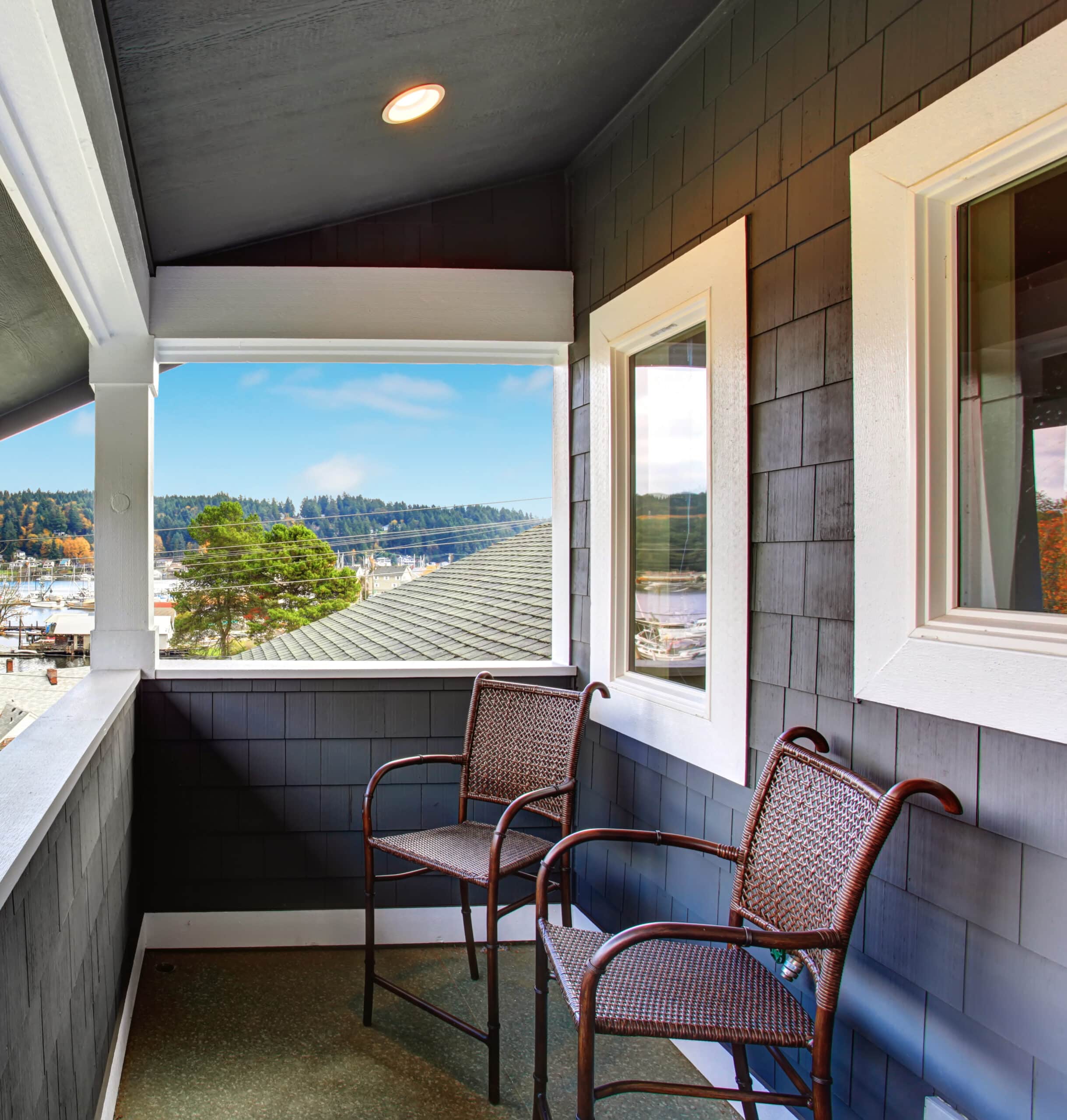 Covered small porch of dark blue Northwest home