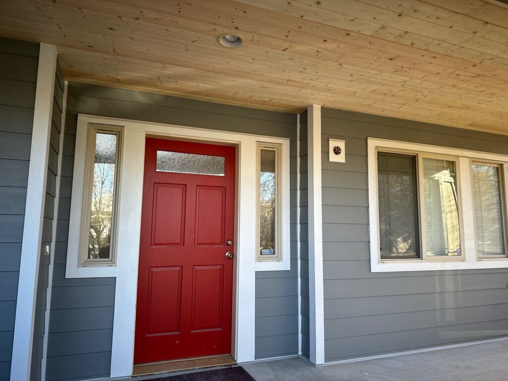 1x6 TG cedar soffit Iron Grey siding, Arctic White trim and red door