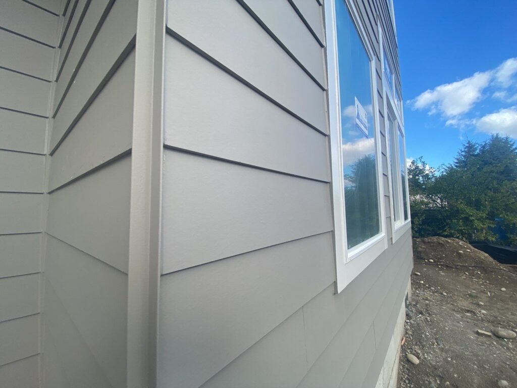 metal corners and fiber cement lap siding with white windows