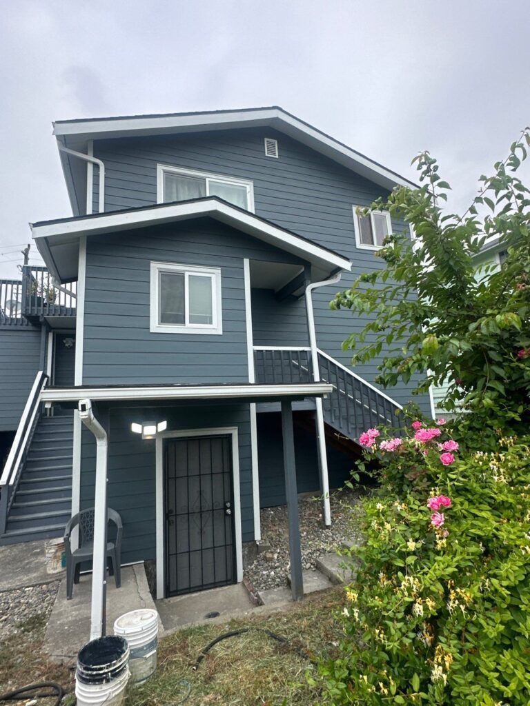 James Hardie fiber cement lap siding in a deep blue tone with white trim on a residential home