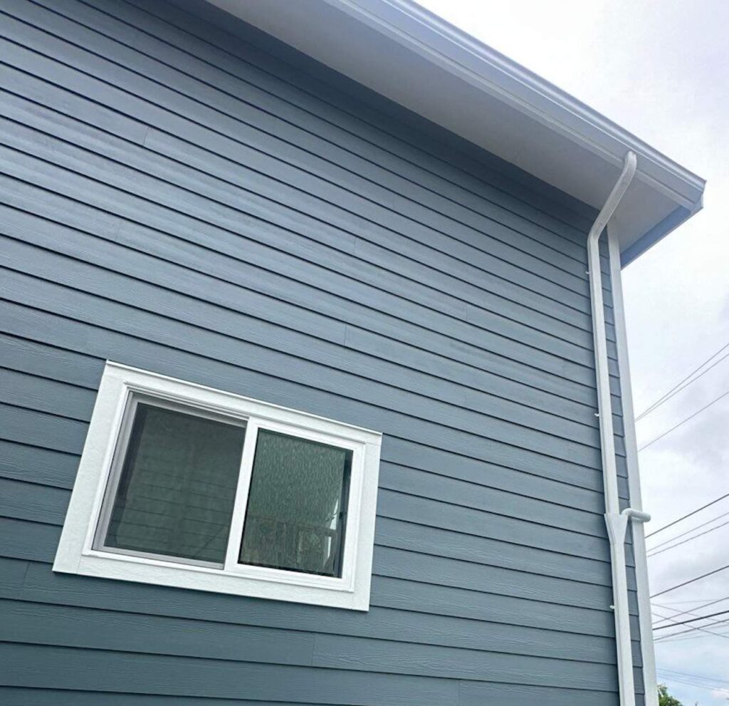 fiber cement siding in james hardie statement collection evening blue color for siding and arctic white color for trim and corners, eaves and soffit