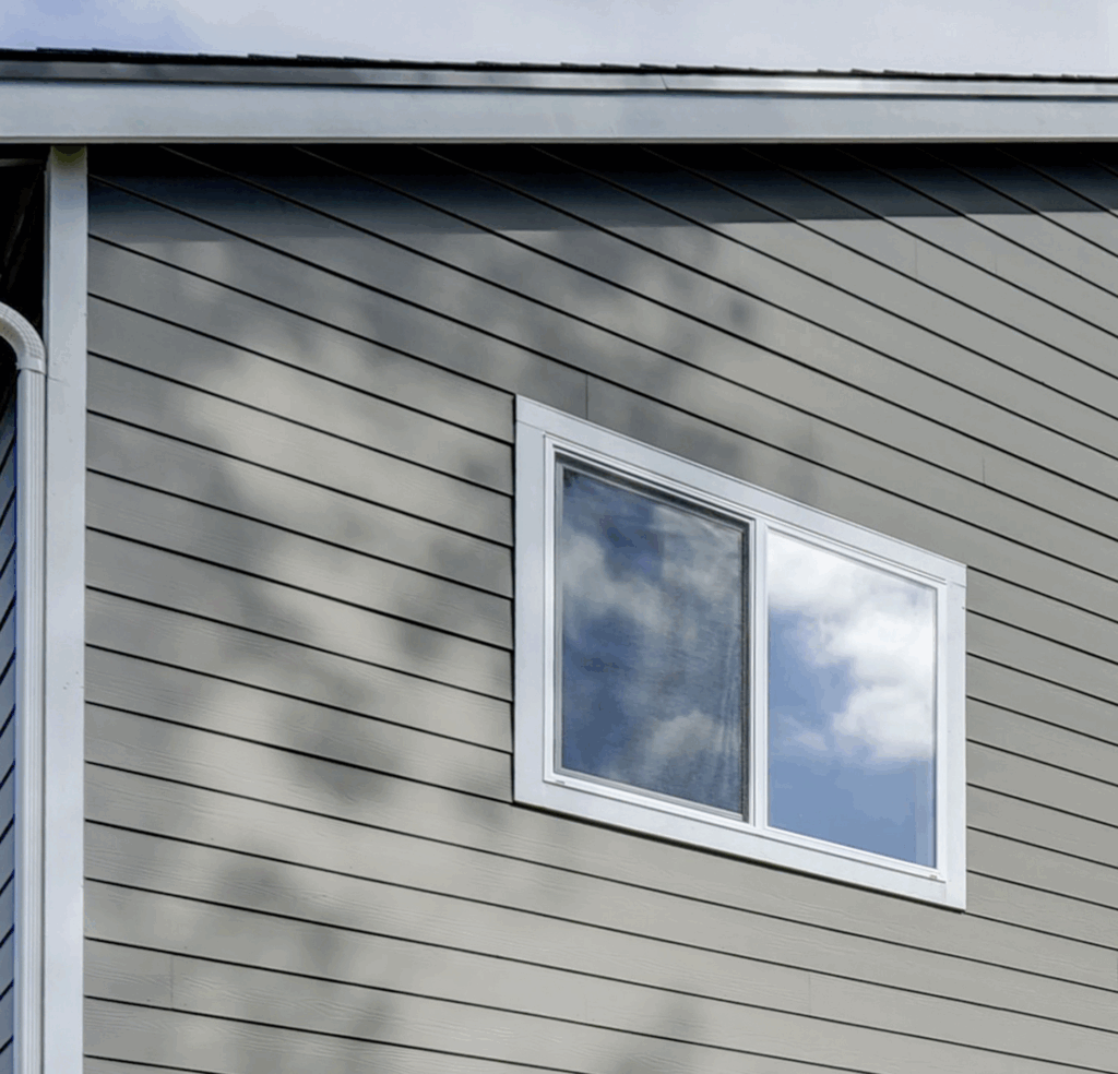 Upper story window framed with white HardieTrim and gray Hardie siding in Mukilteo WA
