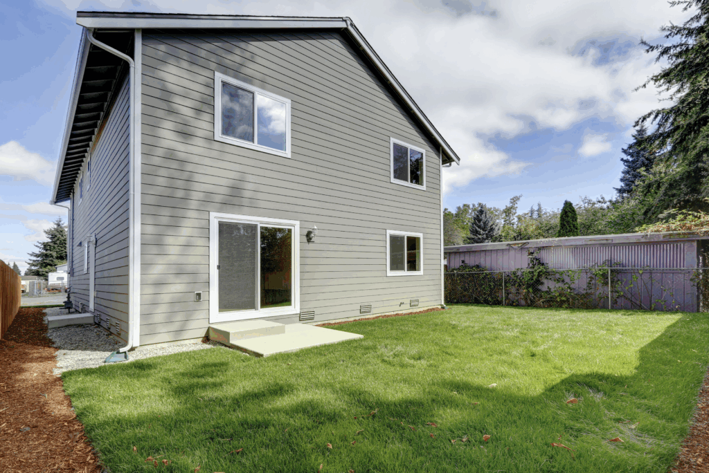 Backyard view showing durable fiber cement siding and white trim on Mukilteo house