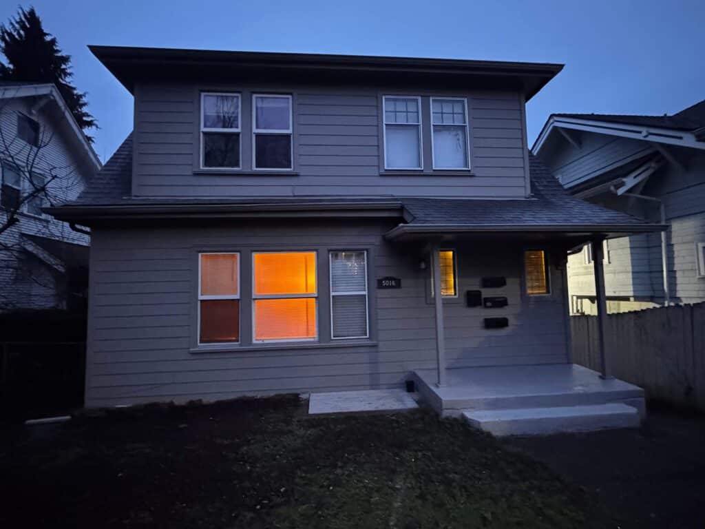 Finished HardiePlank lap siding installation on a Seattle University District home back wall exterior