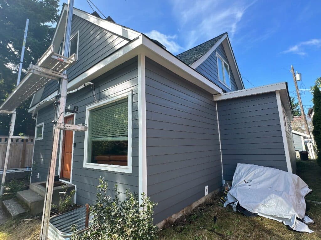Old lead-painted siding removal before James Hardie replacement