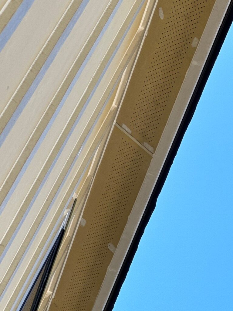 Primed metal H channel outside corners on HardiePanel siding