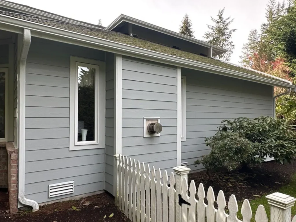 Pre-painted Arctic White Hardie 5/4x4 outside corners, window trim, and door trim installed with James Hardie siding