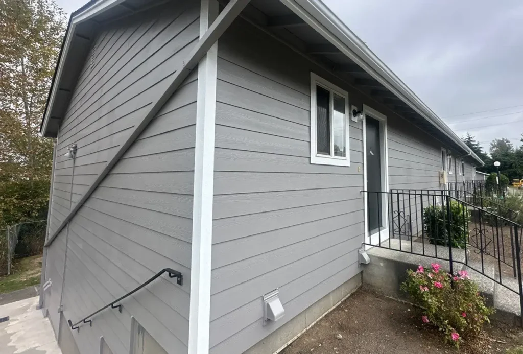 Prime rustic Hardie 5/4x4 outside corners, window trim, and door trim installed on Seattle apartment complex