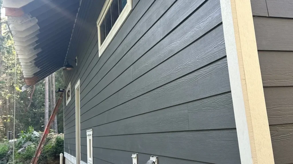 Camano Island project with 8 1/4-inch lap siding at 7-inch reveal; front gable straight-edge shingles; 4x9 panels with 1x3 rustic battens every 16 inches; garage casing wrap with ten 5/4x12 pieces