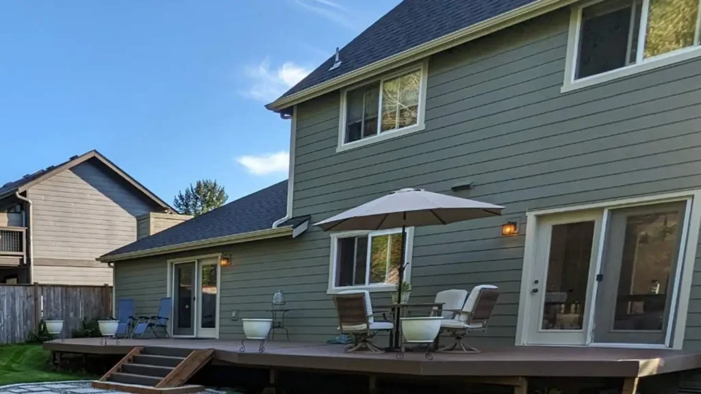 Lake Stevens project with Old siding and all window trim tear-off; HardiePanels + 1x3 battens on chimneys/front gable; selective 5/4x4 trim at front bay windows/garage; white top flashing on side/rear windows