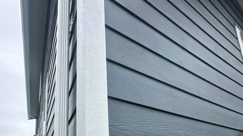 Sedro-Woolley project with Old front siding tear-off; new white gutters/downspouts; pressure wash and two coats Sherwin-Williams SuperPaint in two colors