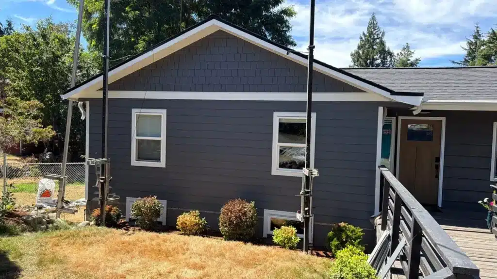 Seattle project with Front gable shingles, 5/4x8 belly-band detail, 8 1/4-inch lap siding at 7-inch reveal, aluminum channel detail between panel seams