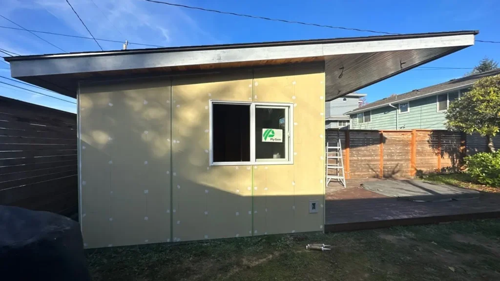 Seattle project with Existing shed exterior; nail heads punched; no documented WRB, flashing, tear-off, OSB, or painting